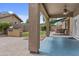 Inviting covered back patio with outdoor kitchen, stone accents, and low maintenance landscaping at 23077 S 214Th St, Queen Creek, AZ 85142