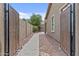 Exterior shot of a backyard featuring a brick pathway and desert landscaping at 23077 S 214Th St, Queen Creek, AZ 85142