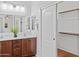 Bathroom featuring a double sink vanity, hardwood cabinets, and a sliding closet door at 23077 S 214Th St, Queen Creek, AZ 85142