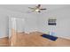Bright bedroom featuring a ceiling fan, light hardwood floors, and a view into the hallway at 23077 S 214Th St, Queen Creek, AZ 85142