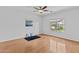 Bright bedroom features a ceiling fan, light hardwood floors, and a sunny window at 23077 S 214Th St, Queen Creek, AZ 85142