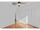 An empty bedroom featuring a ceiling fan, light hardwood flooring, and double closets at 23077 S 214Th St, Queen Creek, AZ 85142