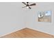 A cozy bedroom featuring a ceiling fan, light hardwood flooring, and a window at 23077 S 214Th St, Queen Creek, AZ 85142