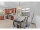 Kitchen dining area features a dark wood table with seating for four and stainless steel appliances at 23077 S 214Th St, Queen Creek, AZ 85142