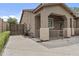 A charming home exterior with desert landscaping, covered patio, and secure gated access at 23077 S 214Th St, Queen Creek, AZ 85142