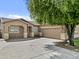 Single story home with well-manicured desert landscaping, spacious driveway, and a two car garage at 23077 S 214Th St, Queen Creek, AZ 85142