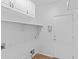 A well lit laundry room with tile floors and plenty of storage space at 23077 S 214Th St, Queen Creek, AZ 85142