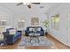 Bright and spacious living room featuring neutral colors, hardwood floors, and lots of natural light at 23077 S 214Th St, Queen Creek, AZ 85142