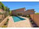 Inviting backyard pool with travertine tile and desert landscaping at 25449 N 102Nd Dr, Peoria, AZ 85383