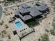 Stunning aerial view of a modern home with a private pool and desert landscaping at 3135 N Mountainside Loop, Buckeye, AZ 85396