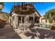 Backyard features a pebble tec pool, covered patio, and dining set with umbrella at 3505 E South Fork Dr, Phoenix, AZ 85044