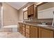Bathroom with double vanity, granite countertops, soaking tub, and natural stone tile at 3505 E South Fork Dr, Phoenix, AZ 85044