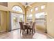 Bright dining area featuring a ceiling fan, ample windows, patio access, and a cozy table with seating for four at 3505 E South Fork Dr, Phoenix, AZ 85044