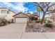 Inviting single-story home with a two-car garage, desert landscaping, and a peaceful residential street view at 3505 E South Fork Dr, Phoenix, AZ 85044