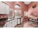 Bright kitchen with granite countertops, stainless steel appliances, and abundant cabinet space; view to the breakfast nook at 3505 E South Fork Dr, Phoenix, AZ 85044