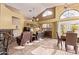Warm and inviting living area featuring high ceilings, a fireplace, comfortable seating, and great natural light at 3505 E South Fork Dr, Phoenix, AZ 85044