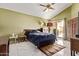 Spacious main bedroom featuring vaulted ceilings, a ceiling fan, and a private doorway to the backyard patio at 3505 E South Fork Dr, Phoenix, AZ 85044