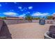 Large backyard with rock landscaping and tall walls for privacy at 36480 W El Greco St, Maricopa, AZ 85138