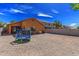 Backyard with a trampoline and rock landscaping and chairs in the background at 36480 W El Greco St, Maricopa, AZ 85138