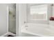 Bright bathroom features a soaking tub next to a shower with glass door at 36480 W El Greco St, Maricopa, AZ 85138