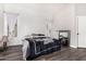 Comfortable bedroom with neutral paint, laminate flooring, and plenty of natural light at 36480 W El Greco St, Maricopa, AZ 85138