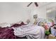 Bedroom with ceiling fan and window and toys at 36480 W El Greco St, Maricopa, AZ 85138