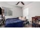 Cozy bedroom features a ceiling fan and sliding door closet at 36480 W El Greco St, Maricopa, AZ 85138