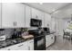 Updated kitchen featuring white cabinets, black appliances, and a marble countertop at 36480 W El Greco St, Maricopa, AZ 85138