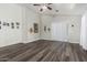 Spacious living room with new flooring, neutral paint, and sliding glass doors for natural light at 36480 W El Greco St, Maricopa, AZ 85138