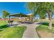 Community playground featuring a picnic area and play structures, perfect for Gathering gatherings and outdoor fun at 36480 W El Greco St, Maricopa, AZ 85138