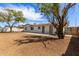 Large backyard featuring a home, concrete patio, and mature trees for shade and enjoyment at 3826 W Davidson Ln, Phoenix, AZ 85051