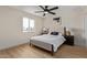 Cozy bedroom featuring neutral tones, a ceiling fan, and a window that provides natural light at 3826 W Davidson Ln, Phoenix, AZ 85051