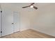 Minimalist bedroom featuring neutral tones, a ceiling fan, and closet for storage at 3826 W Davidson Ln, Phoenix, AZ 85051