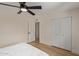 Simple bedroom featuring neutral tones, a ceiling fan, and closet for storage at 3826 W Davidson Ln, Phoenix, AZ 85051