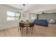 Inviting dining area with wood flooring and modern lighting, seamlessly connected to the living space at 3826 W Davidson Ln, Phoenix, AZ 85051