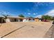 Attractive single-story home featuring a long driveway and desert landscaping in a sunny neighborhood at 3826 W Davidson Ln, Phoenix, AZ 85051