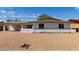 Inviting single-story home with a low brick wall, desert landscaping, and a covered carport at 3826 W Davidson Ln, Phoenix, AZ 85051
