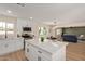 Bright kitchen featuring white cabinets, stainless steel appliances, and a large island with a white countertop at 3826 W Davidson Ln, Phoenix, AZ 85051