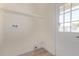 Functional laundry area with modern hookups, shelving, and a door to the outside at 3826 W Davidson Ln, Phoenix, AZ 85051