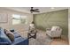 Stylishly decorated living room with a textured accent wall and ample natural light at 3826 W Davidson Ln, Phoenix, AZ 85051