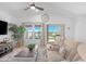 Comfortable living area with large sectional, ceiling fan, view of lake and stylish decor at 40365 W Bravo Dr, Maricopa, AZ 85138