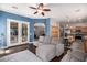 Open-concept living room featuring a large sectional couch, ceiling fan, and hardwood floors at 4667 E County Down Dr, Chandler, AZ 85249