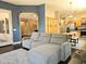 Open-concept living room featuring a plush gray sofa and views into kitchen at 4667 E County Down Dr, Chandler, AZ 85249