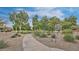 Coyote Crossing Park featuring a paved path, lush landscaping, and a welcoming sign, a serene outdoor space at 4667 E County Down Dr, Chandler, AZ 85249