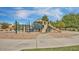Community playground featuring a slide, swings, and climbing structures on a sand base, perfect for Gathering fun at 4667 E County Down Dr, Chandler, AZ 85249
