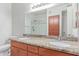Bathroom featuring dual sinks, granite counters, wood cabinets and glass enclosed shower at 5302 E Van Buren St # 2015, Phoenix, AZ 85008
