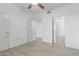 Bright bedroom with light grey wood-look floors, ceiling fan and walk-in closet at 5302 E Van Buren St # 2015, Phoenix, AZ 85008