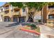 Apartment building exterior featuring well-maintained landscaping, covered parking, and convenient stair access at 5302 E Van Buren St # 2015, Phoenix, AZ 85008