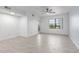 Bright living room showcasing tile flooring, a ceiling fan, and natural light from the window at 5302 E Van Buren St # 2015, Phoenix, AZ 85008