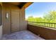 Outdoor patio with storage closet, tile floors, and views of the trees and sky at 5302 E Van Buren St # 2015, Phoenix, AZ 85008